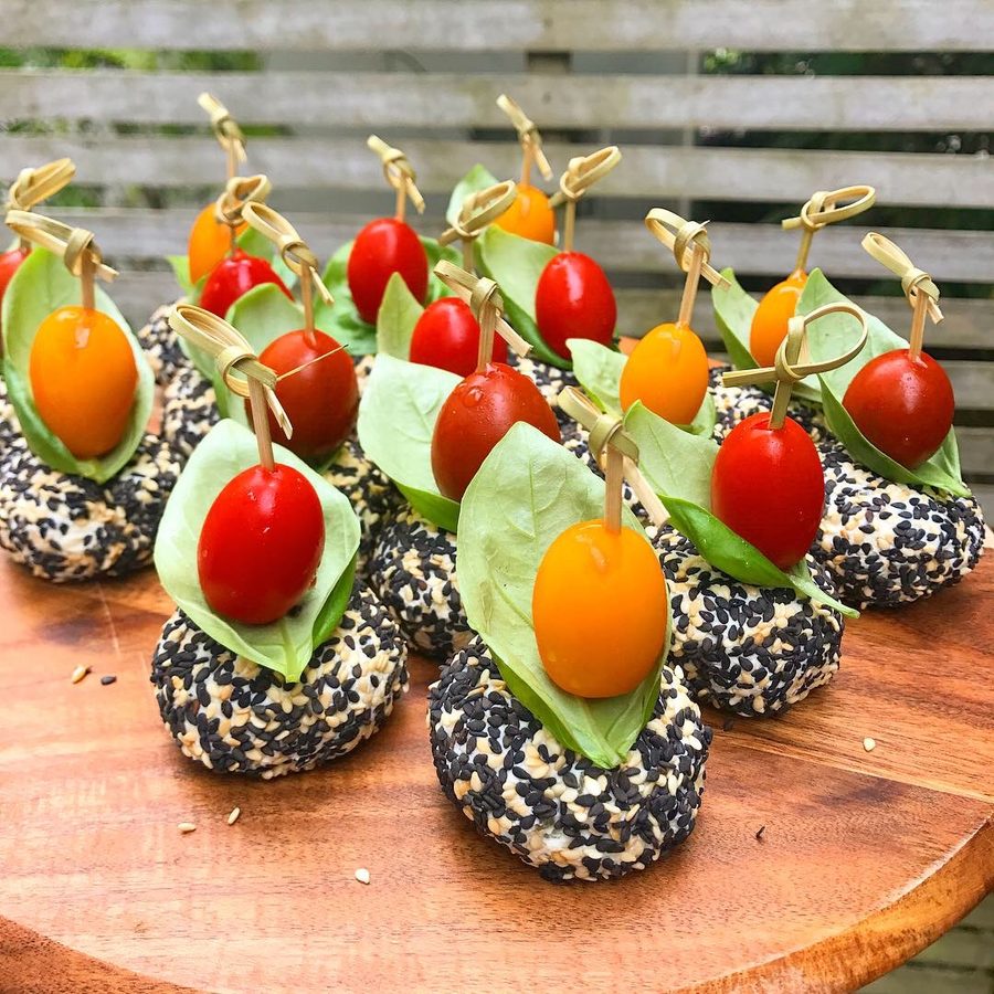 Cherry tomato and basil canapés on seeded crackers