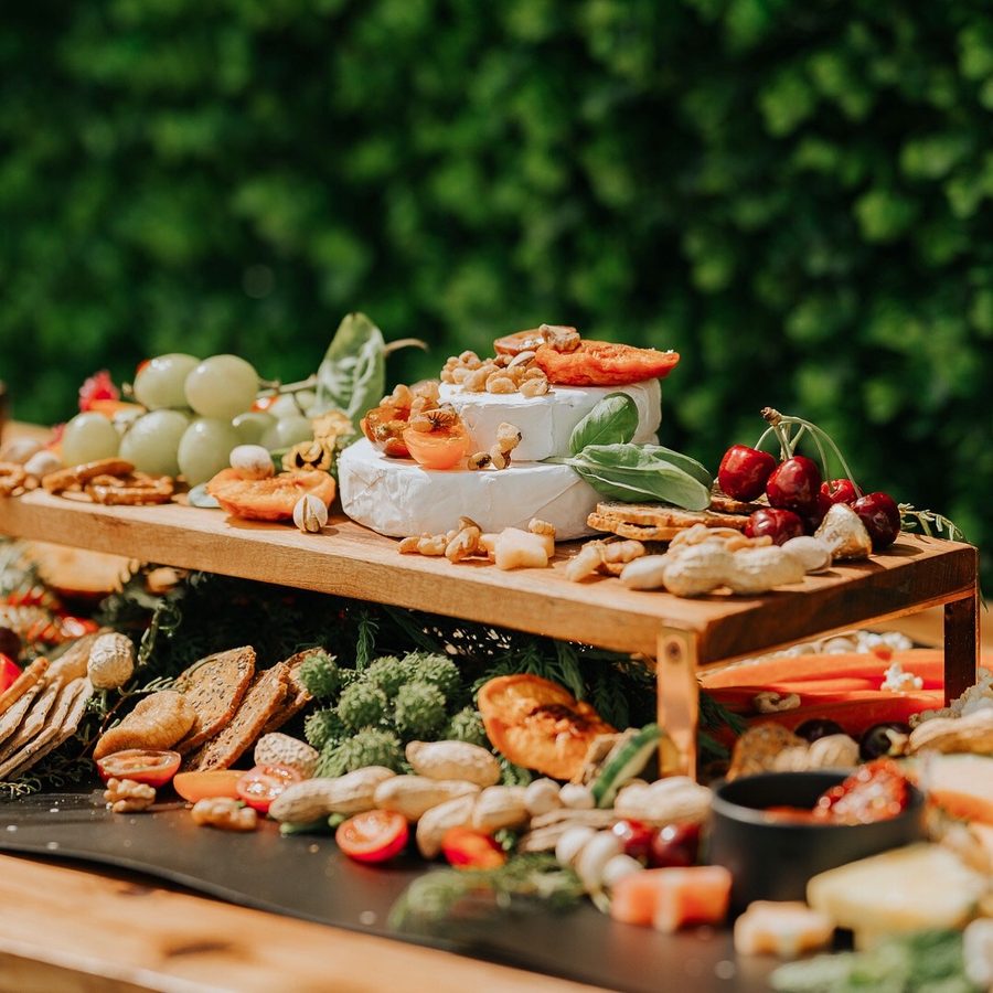 A tiered gluten-free grazing table styled outdoors