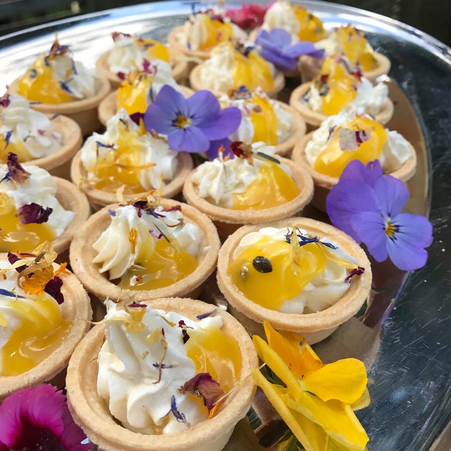 Mini gluten-free tarts with cream and edible pansies
